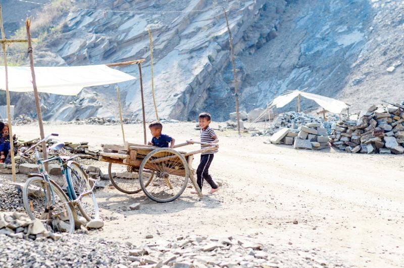 Two children playing in a hand cart near a quarry in Kuthur village of Tuensang district. (Morung Photo by Moses Hongang Chang)
